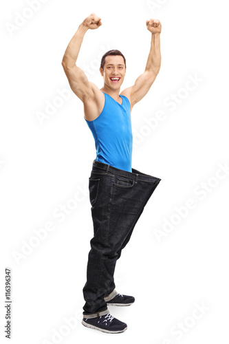 Muscular man in oversized jeans