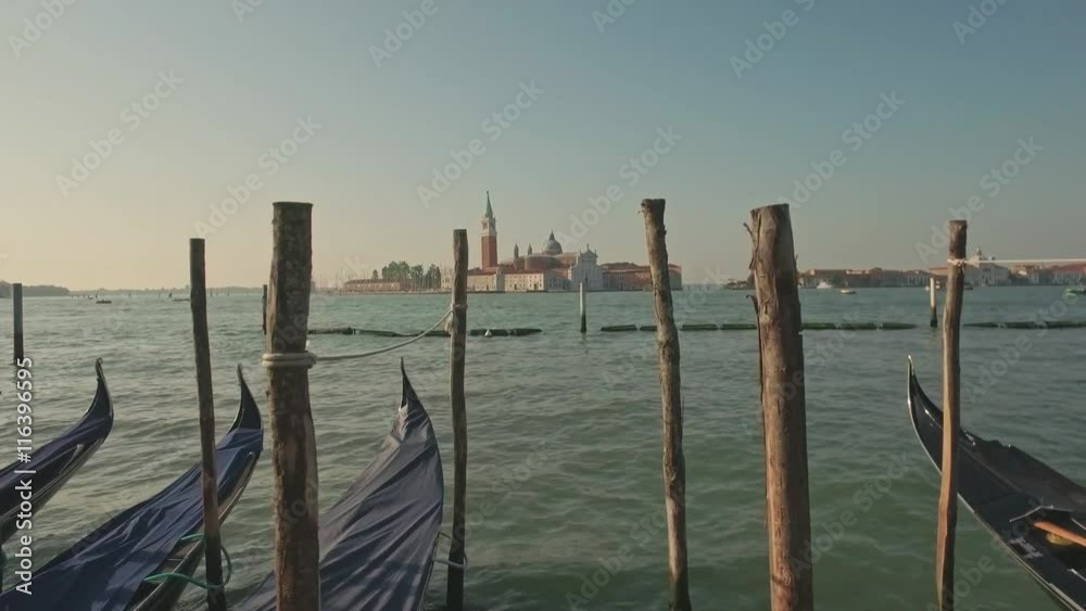 Parking gandolas on the Doge's palace embankment with the bell tower of the Saint Giorgio Maggiore church view. Parking gandolas on the Doge's palace embankment with the bell tower of the Saint Giorgio Maggiore church view.