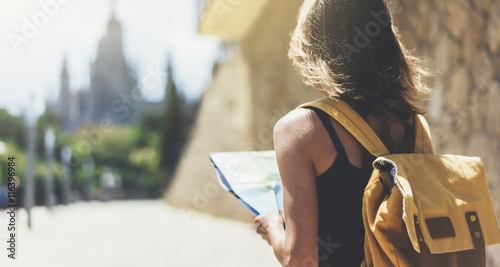 Photography Hipster young girl with bright backpack and fashion sunglasses looking at map