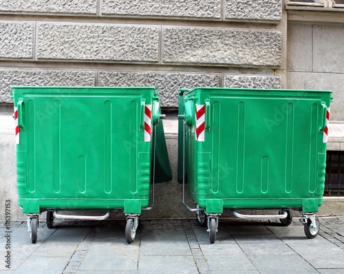 Two green garbage bins