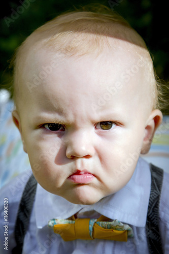Portrait of an angry little boy. Selective soft focus