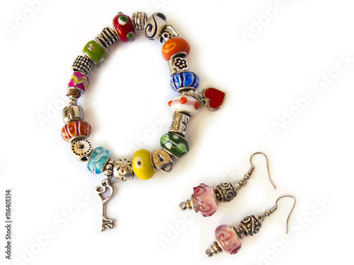 Beads and gems bracelet, and a pair of earrings, isolated in white