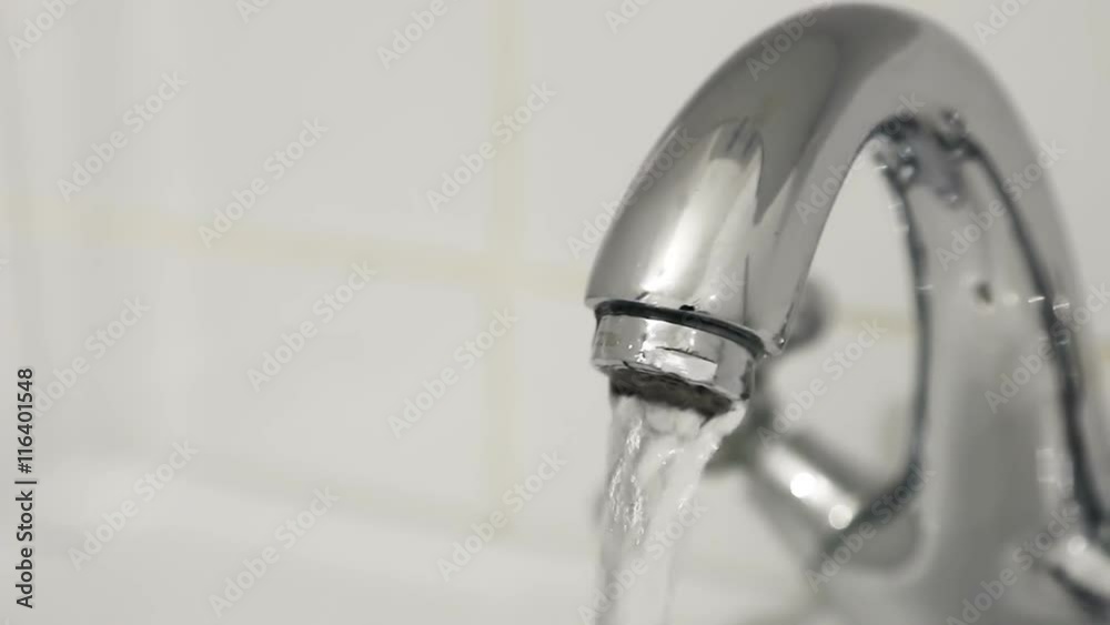 faucet turned on filling the sink with water faucet turned on filling the sink with water