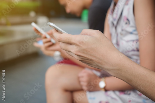 close up group of teenager playing smartphone concept