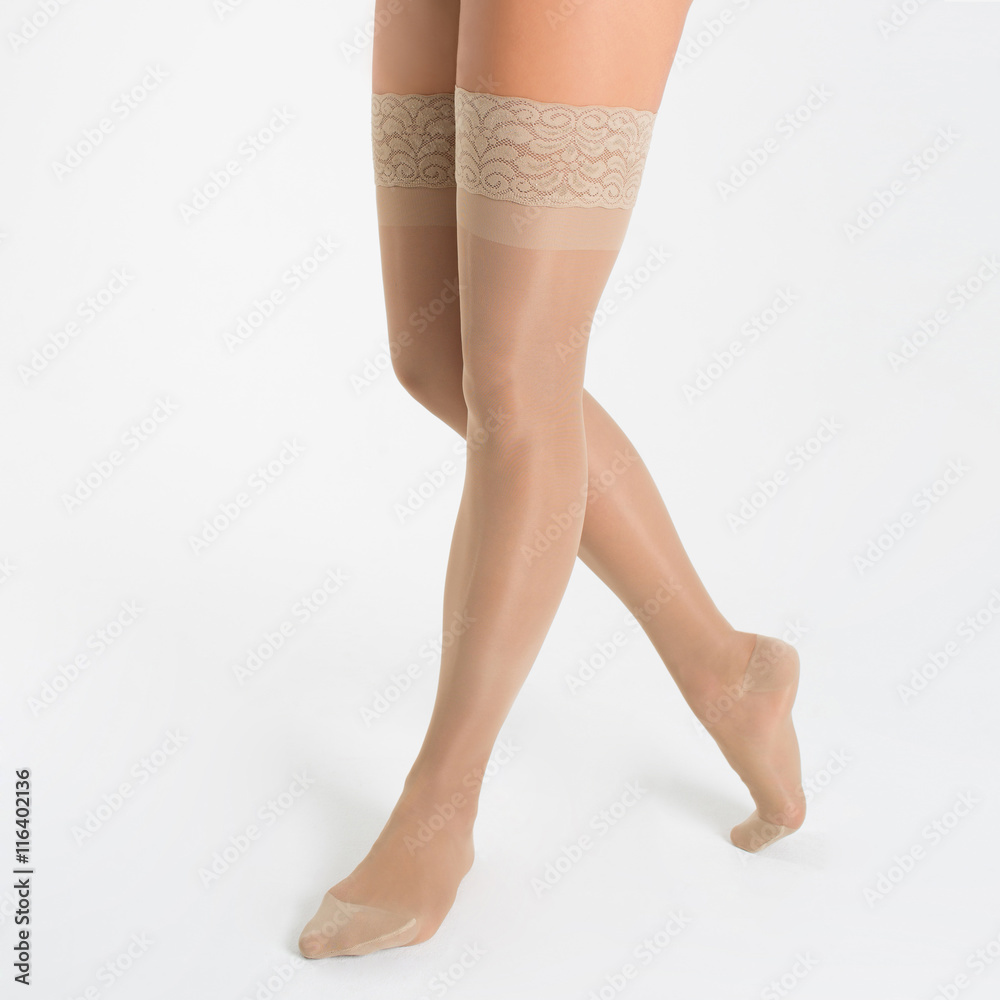 Female legs in stockings on white background Female legs in stockings on white background
