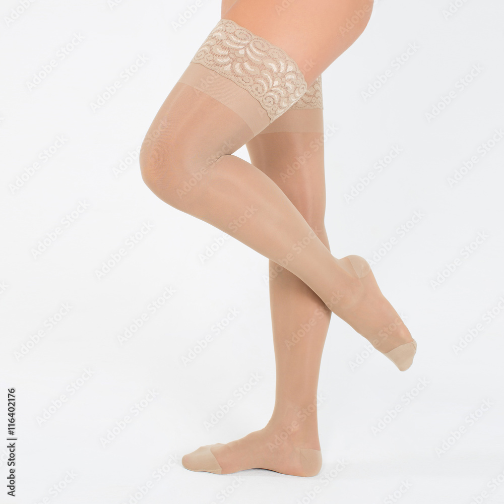 Female legs in stockings on white background Female legs in stockings on white background
