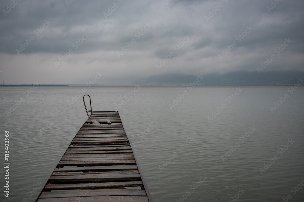 Fototapeta premium Old wooden dock in summer stormy weather
