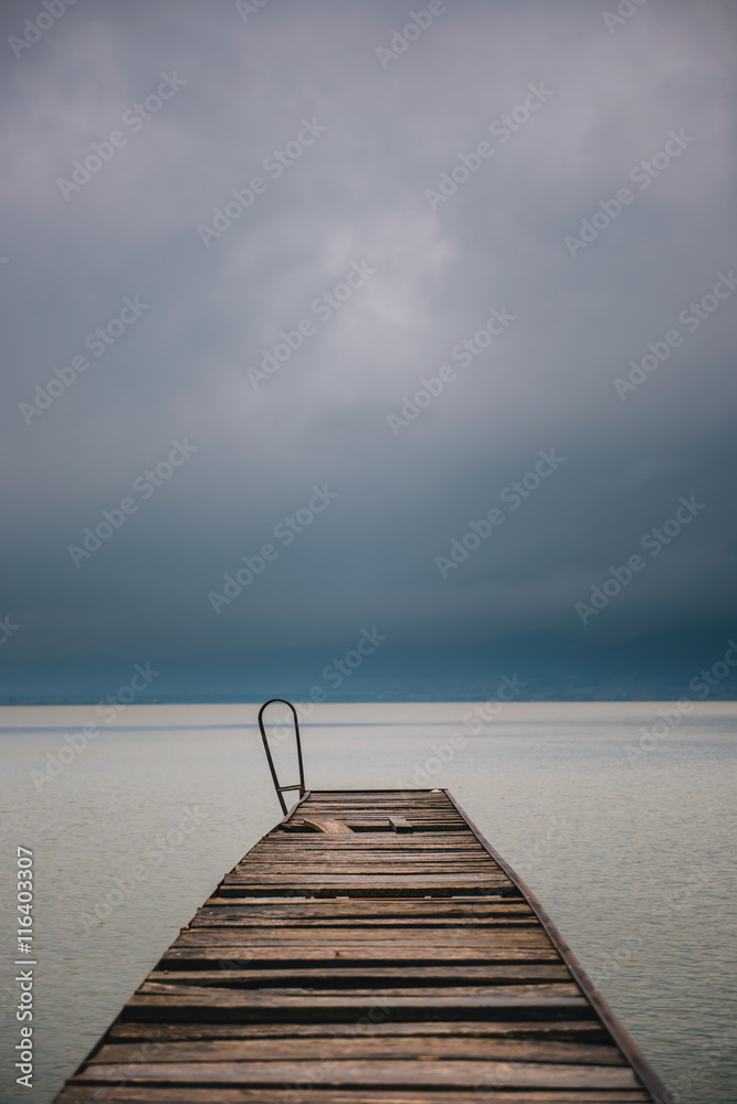 Old wooden dock in summer stormy weather