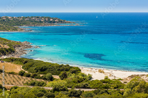 Holidaymakers and turquoise Mediterranean at Bodri beach in Cors
