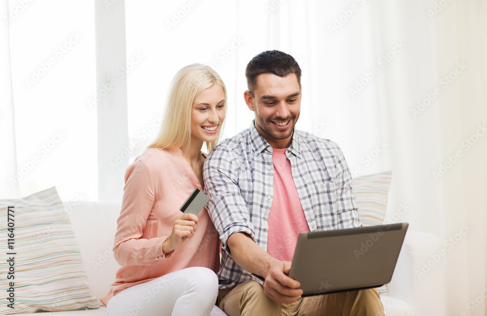 happy couple with laptop and credit card at home happy couple with laptop and credit card at home
