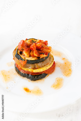 A white plate with ratatouille