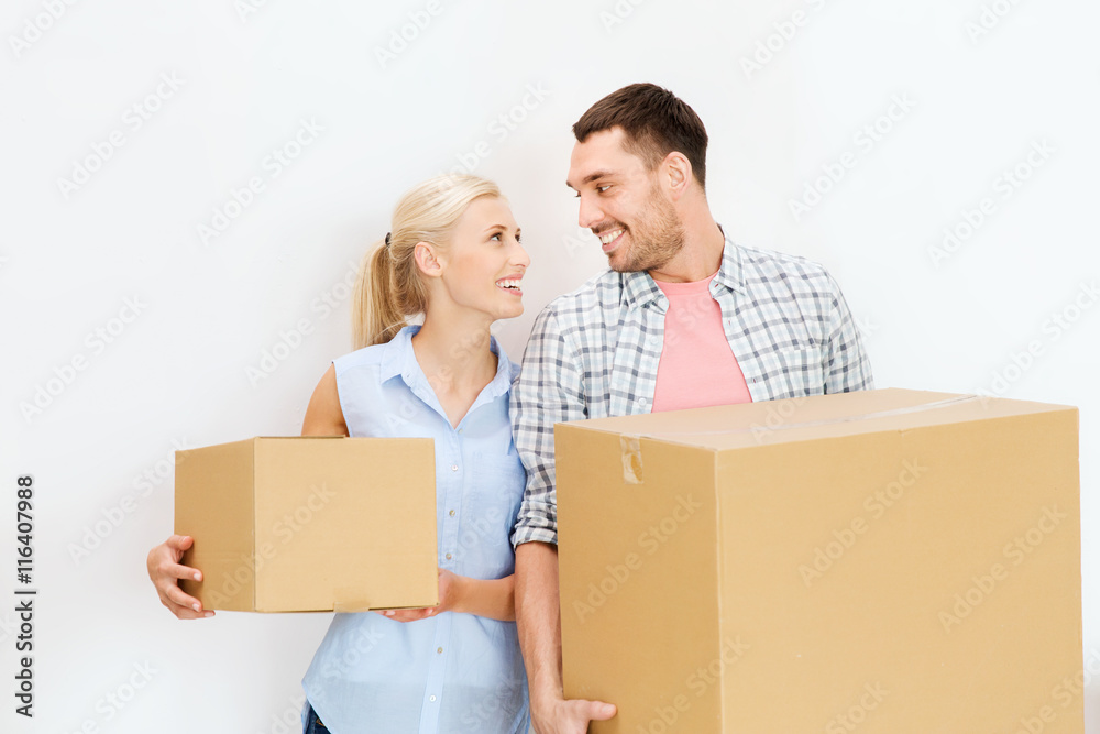 couple with cardboard boxes moving to new home couple with cardboard boxes moving to new home