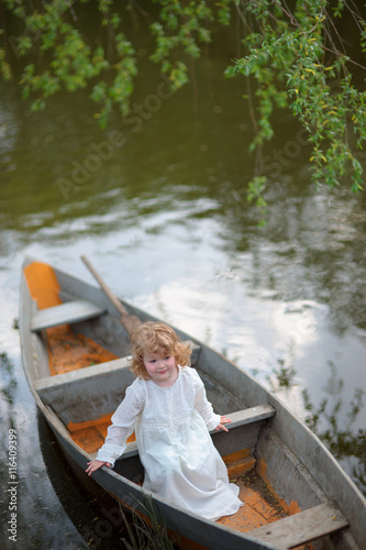 small girl in the boat at the river © sasapanchenko