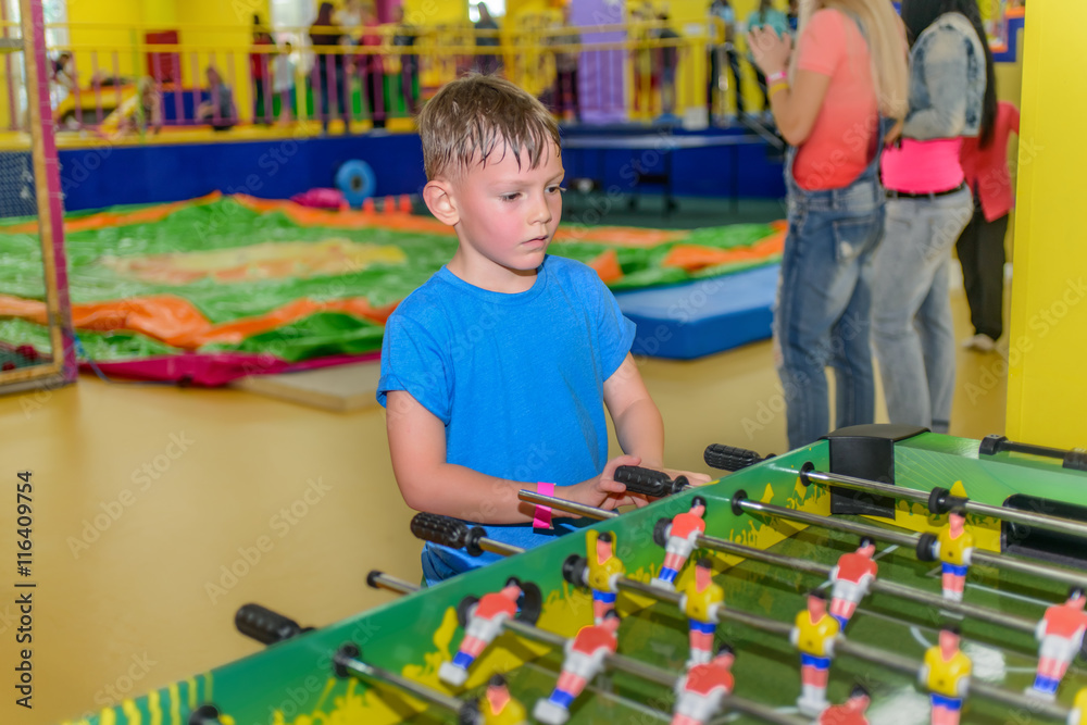 Little boy playing a table board game of soccer Little boy playing a table board game of soccer