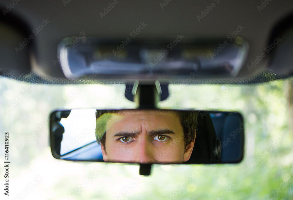 Grimmiger Blick im Rückspiegel StockFoto Adobe Stock