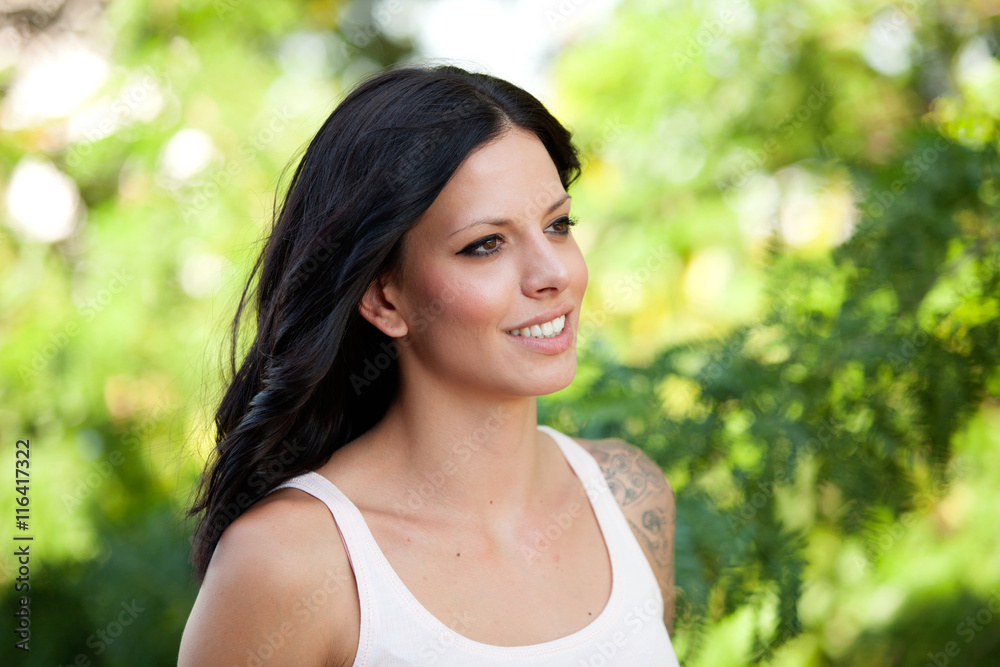 Beautiful brunette girl relaxing in the park Beautiful brunette girl relaxing in the park