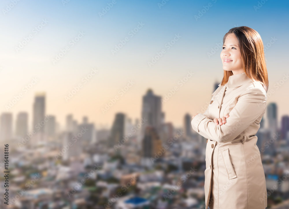 asian businesswoman arm crossed with cityscape background