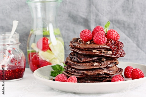 Chocolate pancakes with fresh raspberries. Selective focus 