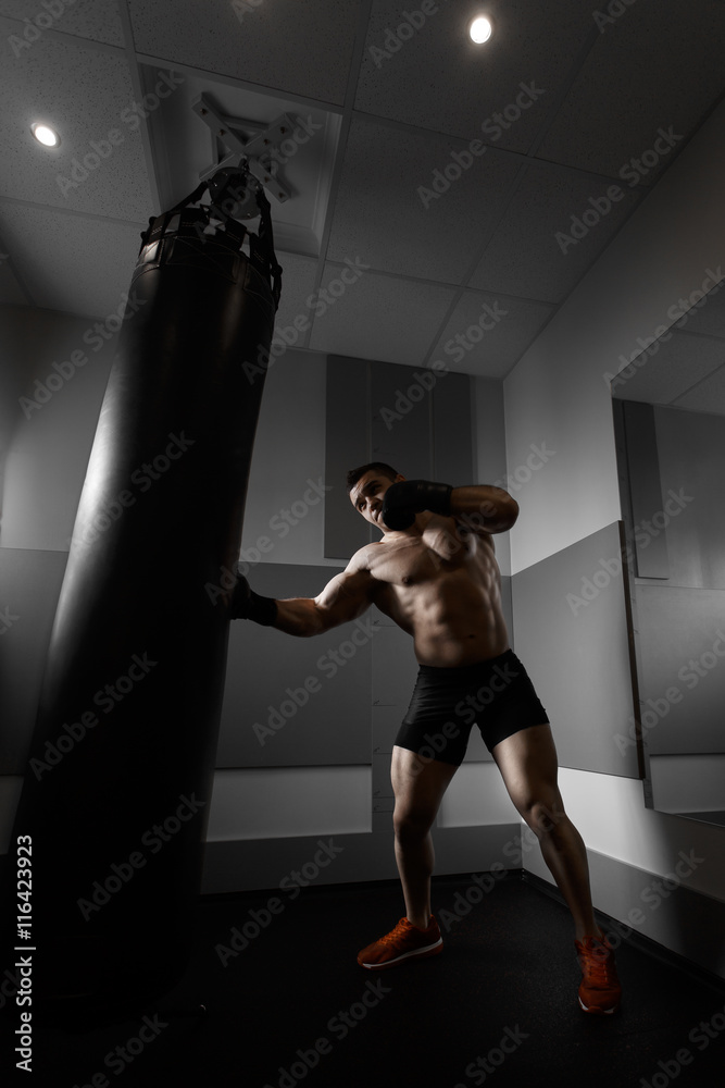 Young boxer trains on punching bag Young boxer trains on punching bag