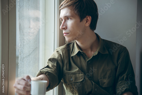 Bilde på lerret romantic pensive man with cup of coffee