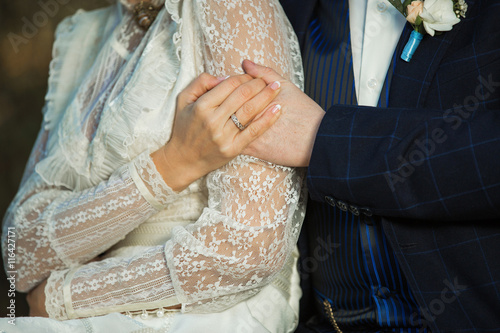 Фотография couple tenderly holding hands in retro clothes,outdoors