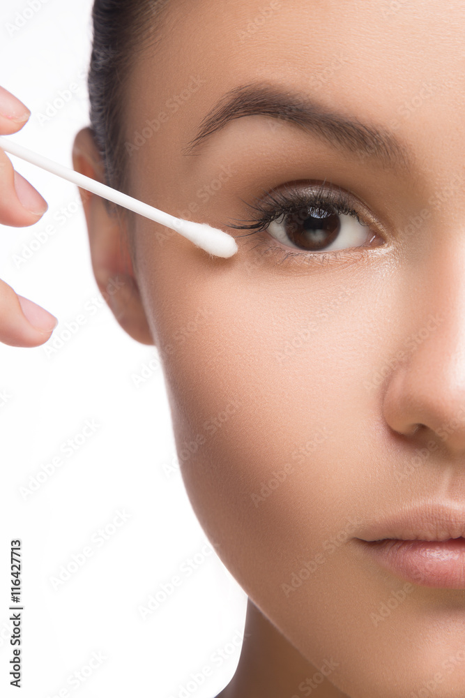 bright closeup portrait picture of beautiful woman with cotton bud. spa concept on white