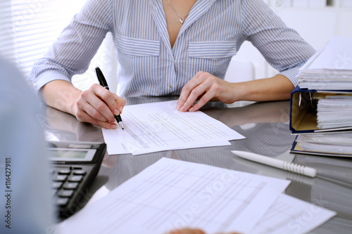 Bookkeepers or financial inspector making report, calculating or checking balance. Audit concept. photo