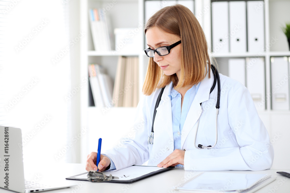 Female doctor writing a medical prescription at clipboard Stock Photo ...
