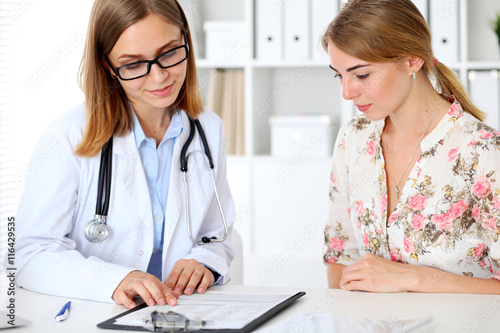 Doctor and patient sitting at the desk Doctor and patient sitting at the desk