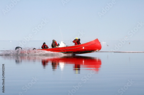 Red canoe in Arctic Ocean photo