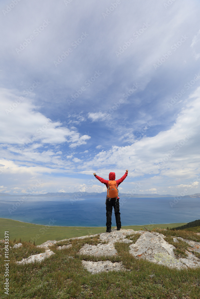 cheering successful woman backpacker open arms on mountain peak cheering successful woman backpacker open arms on mountain peak