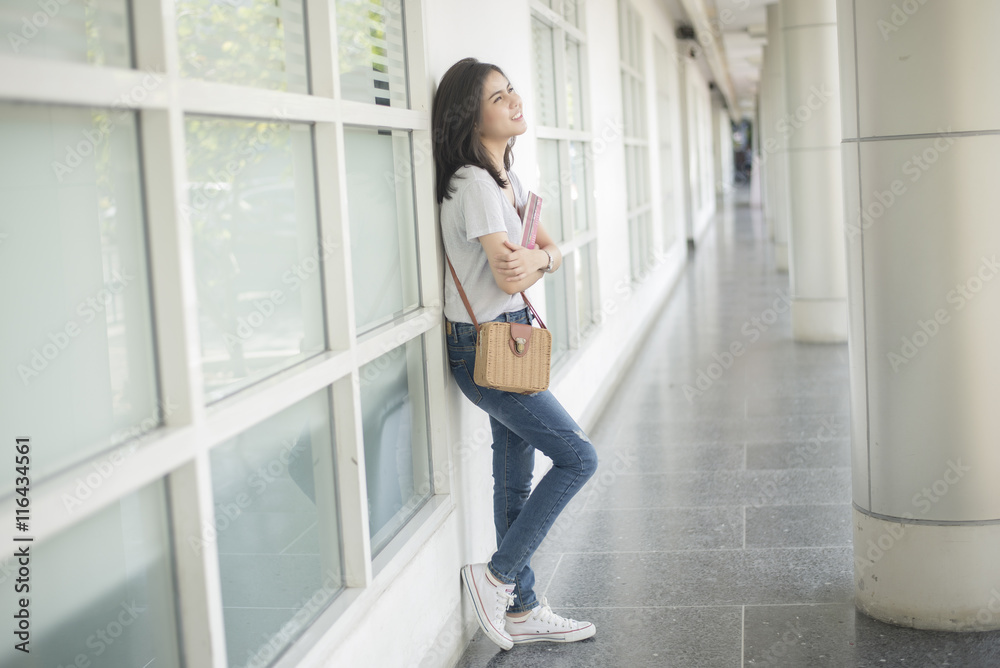 Fototapeta premium A portrait of an Asian university student on campus