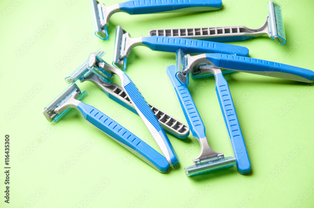 The image of blue razor blades ona a green bakground