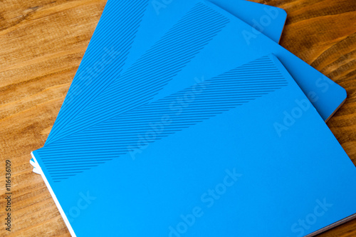 Blue school notebooks on a wooden table