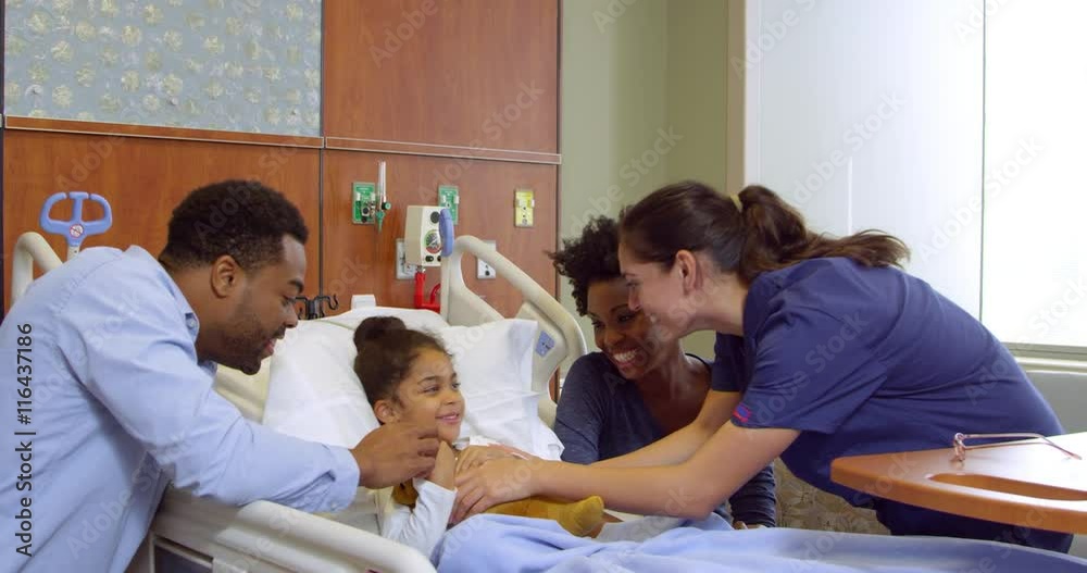 Nurse With Parents And Child In Hospital Ward Nurse With Parents And Child In Hospital Ward