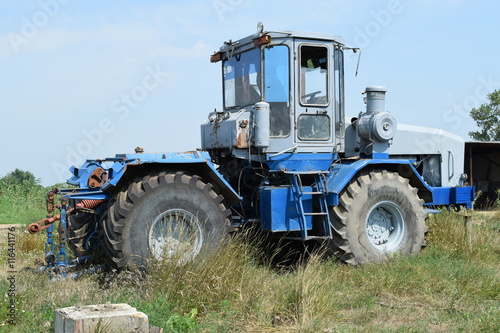 Tractor  standing in a row. Agricultural machinery.