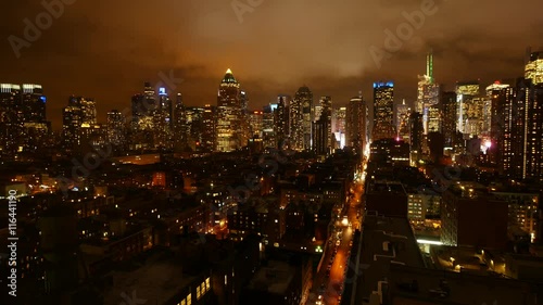 Wallpaper Mural urban building lights background. clouds moving over city skyline at night sky Torontodigital.ca