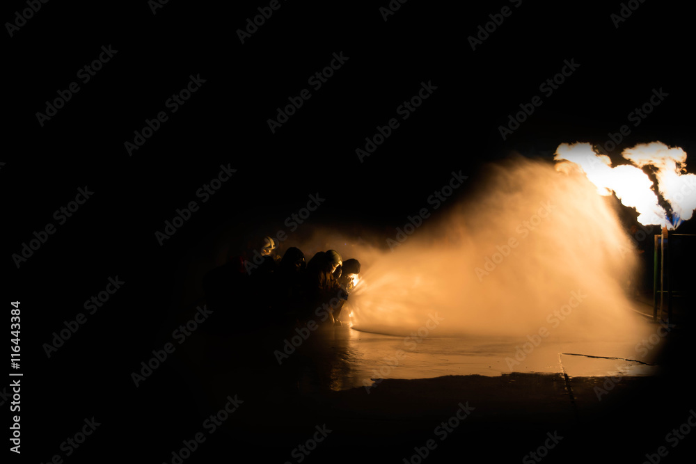 Obraz premium Firefighter Fireman Attack Fire with High Pressure Water