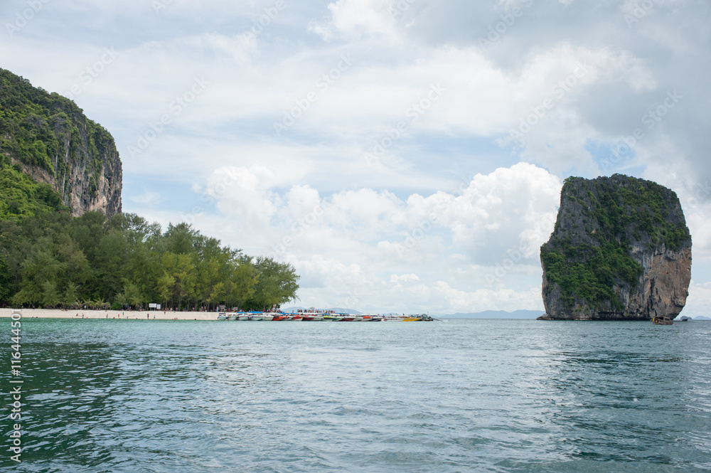 Poda Island, Speed boats and Thai traditional boat anchored in a amazing blue water beach in Krabi, Thailand. Poda Island, Speed boats and Thai traditional boat anchored in a amazing blue water beach in Krabi, Thailand.