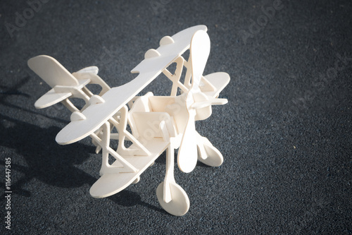 Wallpaper Mural close up photo of wooden toy airplane against  on road Torontodigital.ca