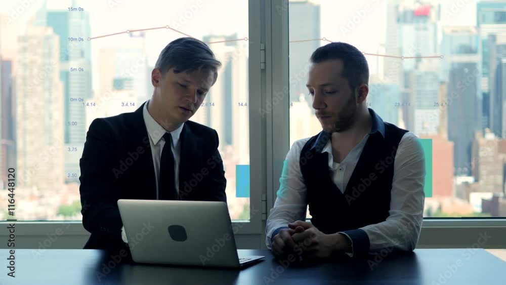 business meeting scene of two businessman analyzing charts and diagrams business meeting scene of two businessman analyzing charts and diagrams