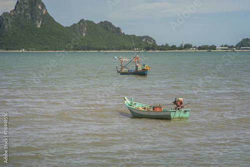 traditional fishing boat laying on a wave of the sea,filtered image,selective focus,thailand