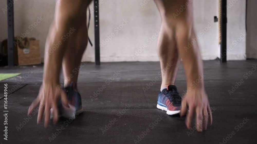 Burpees and deadlift - young athlete doing WOD at the gym Burpees and deadlift - young athlete doing WOD at the gym