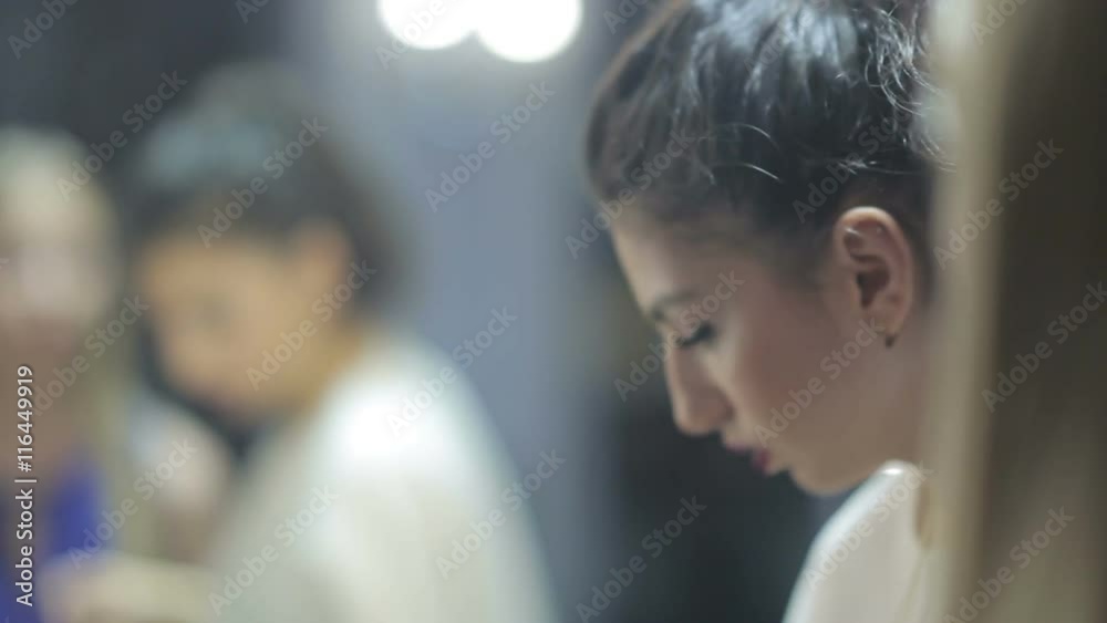 Stylist making make-up of a beautiful young model. Stylist making make-up of a beautiful young model.