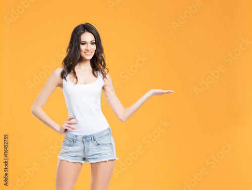 Young woman with a perfect body in jeans and a shirt