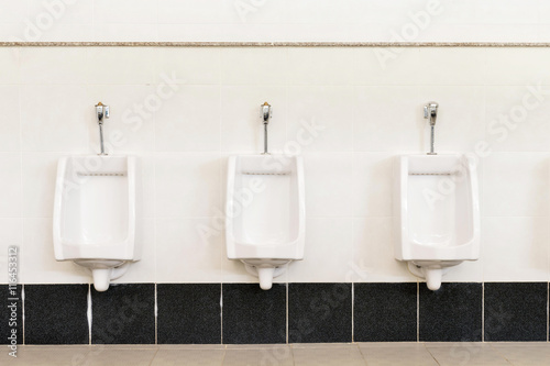 white urinals ceramic in men's bathroom