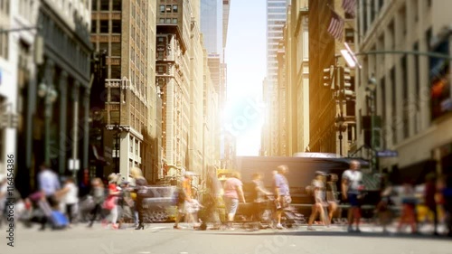 crowd of people crossing street in new york city. workers commuting background