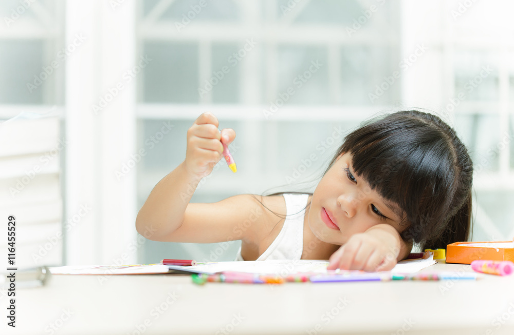 Thoughtful girl reading a book and using her imagination Thoughtful girl reading a book and using her imagination