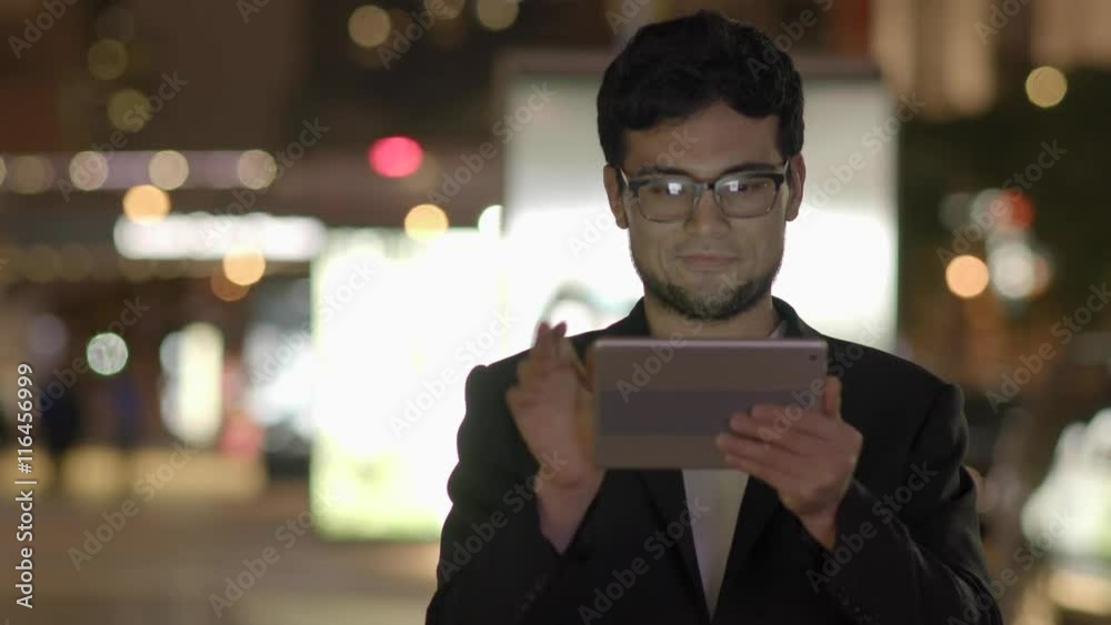 modern mobil device technology background. asian man surfing the web on  tablet