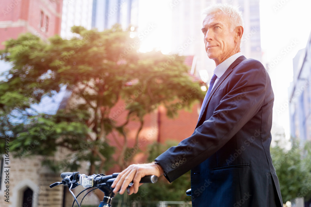 Fototapeta premium Successful businessman riding bicycle